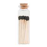 Petite glass jar with black-tipped wooden matches and cork lid for safe storage.