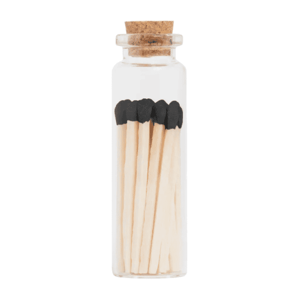 Petite glass jar with black-tipped wooden matches and cork lid for safe storage.