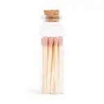 Small glass bottle with pink-tipped matches and cork stopper.