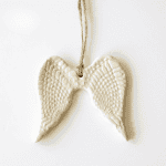 Handmade ceramic angel wing ornament for nurturing and spiritual decor.
