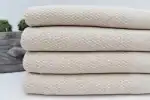 Soft, neutral-colored woven fabric folded neatly, ideal for home decor or upholstery projects.