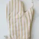 Linen oven mitt with beige and white vertical stripes for kitchen use.