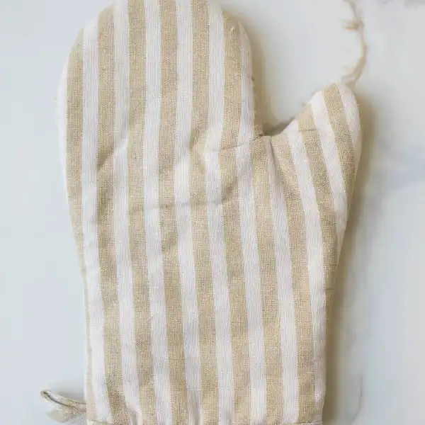 Linen oven mitt with beige and white vertical stripes for kitchen use.