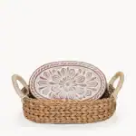 Handcrafted ceramic plate in a woven basket for home decor or serving.