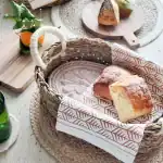 Soft, homemade bread in a woven basket with a rustic setting, perfect for nurturing wellness and com.