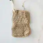 Natural jute soap saver pouch with drawstring closure designed to create rich lather, gently exfoliate skin, and extend the life of soap bars in an eco-friendly bath routine.