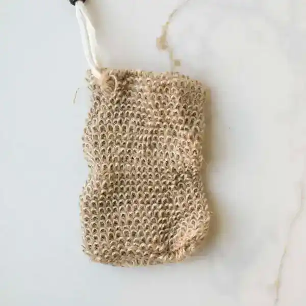 Natural jute soap saver pouch with drawstring closure designed to create rich lather, gently exfoliate skin, and extend the life of soap bars in an eco-friendly bath routine.
