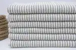 Soft, patterned fabric stacked neatly for bedding or home decor.