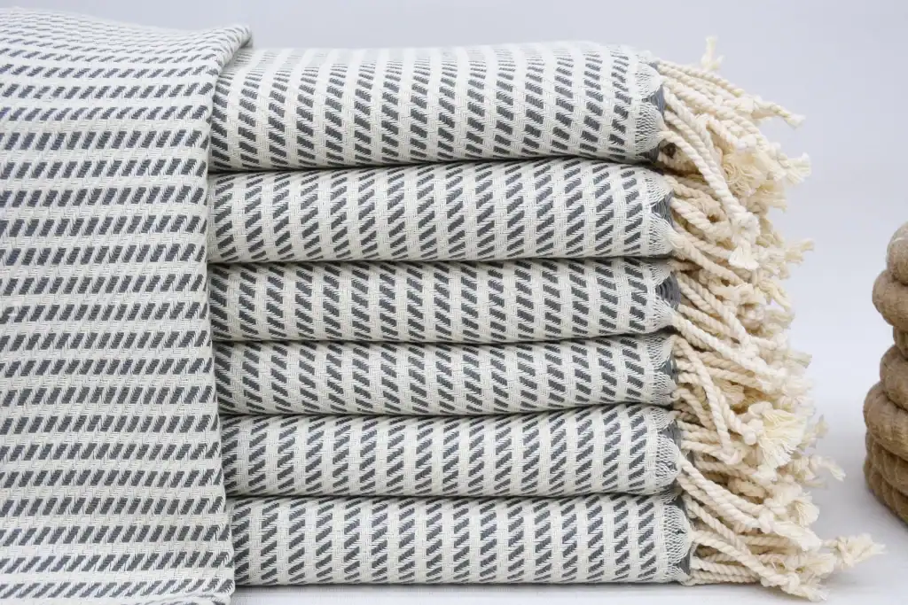 Soft, striped woven kitchen towel stacked neatly for cozy comfort and home decor.