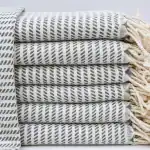 Soft, striped woven kitchen towel stacked neatly for cozy comfort and home decor.