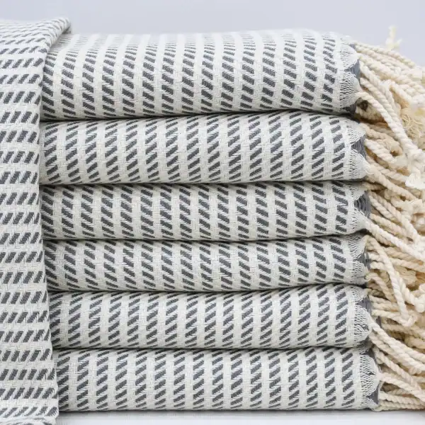Soft, striped woven kitchen towel stacked neatly for cozy comfort and home decor.