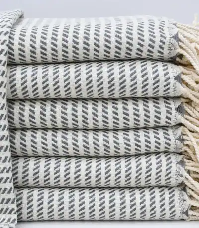Soft, striped woven kitchen towel stacked neatly for cozy comfort and home decor.
