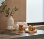 Relaxing spa setting with towels, brushes, and greenery for wellness and self-care.