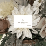 Elegant floral gift card with white and blush flowers, greenery, and a modern design for Nurtured Co.