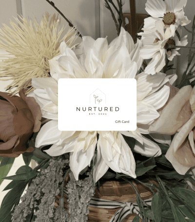Elegant floral gift card with white and blush flowers, greenery, and a modern design for Nurtured Co.