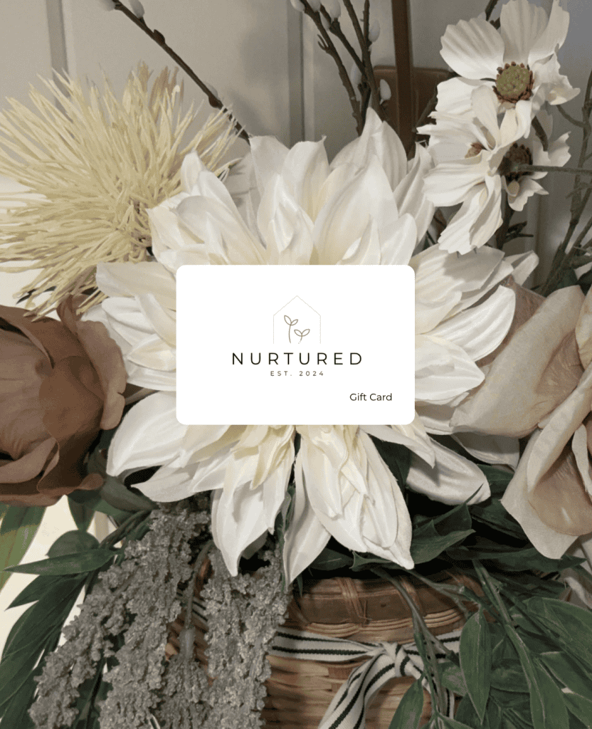 Elegant floral gift card with white and blush flowers, greenery, and a modern design for Nurtured Co.