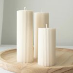 Hand-poured ribbed soy wax pillar candle with a minimalist sculptural design, styled in soft neutral tones for modern home décor, cozy ambiance, and elevated everyday living.