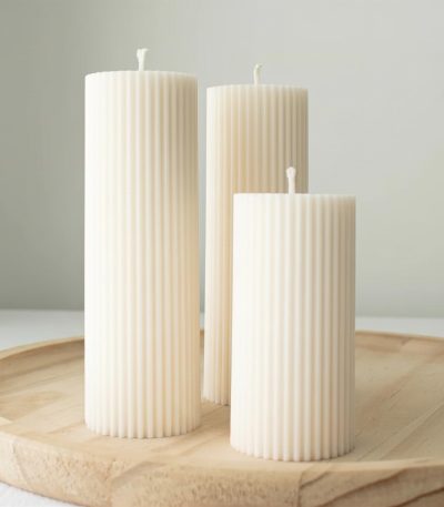 Hand-poured ribbed soy wax pillar candle with a minimalist sculptural design, styled in soft neutral tones for modern home décor, cozy ambiance, and elevated everyday living.