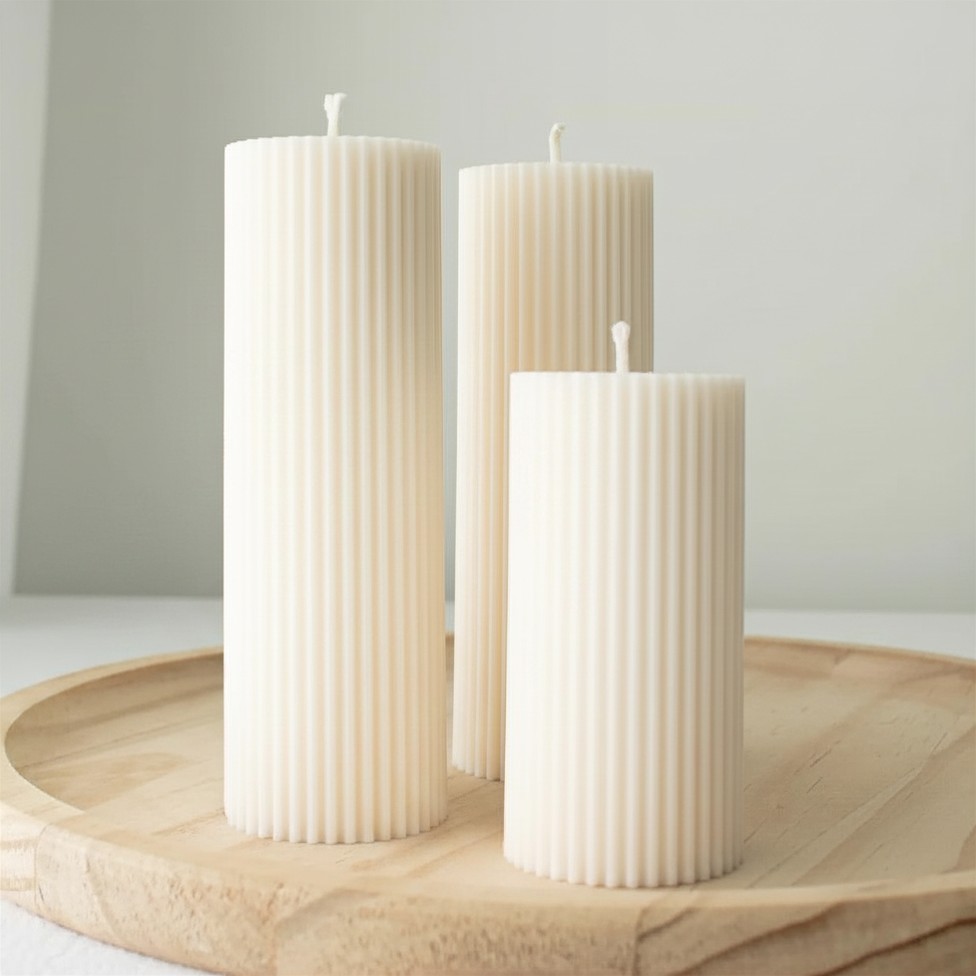 Hand-poured ribbed soy wax pillar candle with a minimalist sculptural design, styled in soft neutral tones for modern home décor, cozy ambiance, and elevated everyday living.