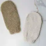 Soft exfoliating bath mitts in neutral tones for skincare routines.