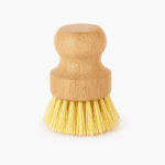 Soft non-scratch sisal dish brush with a natural wooden handle and gentle yellow plant-based bristles displayed on a clean white background.