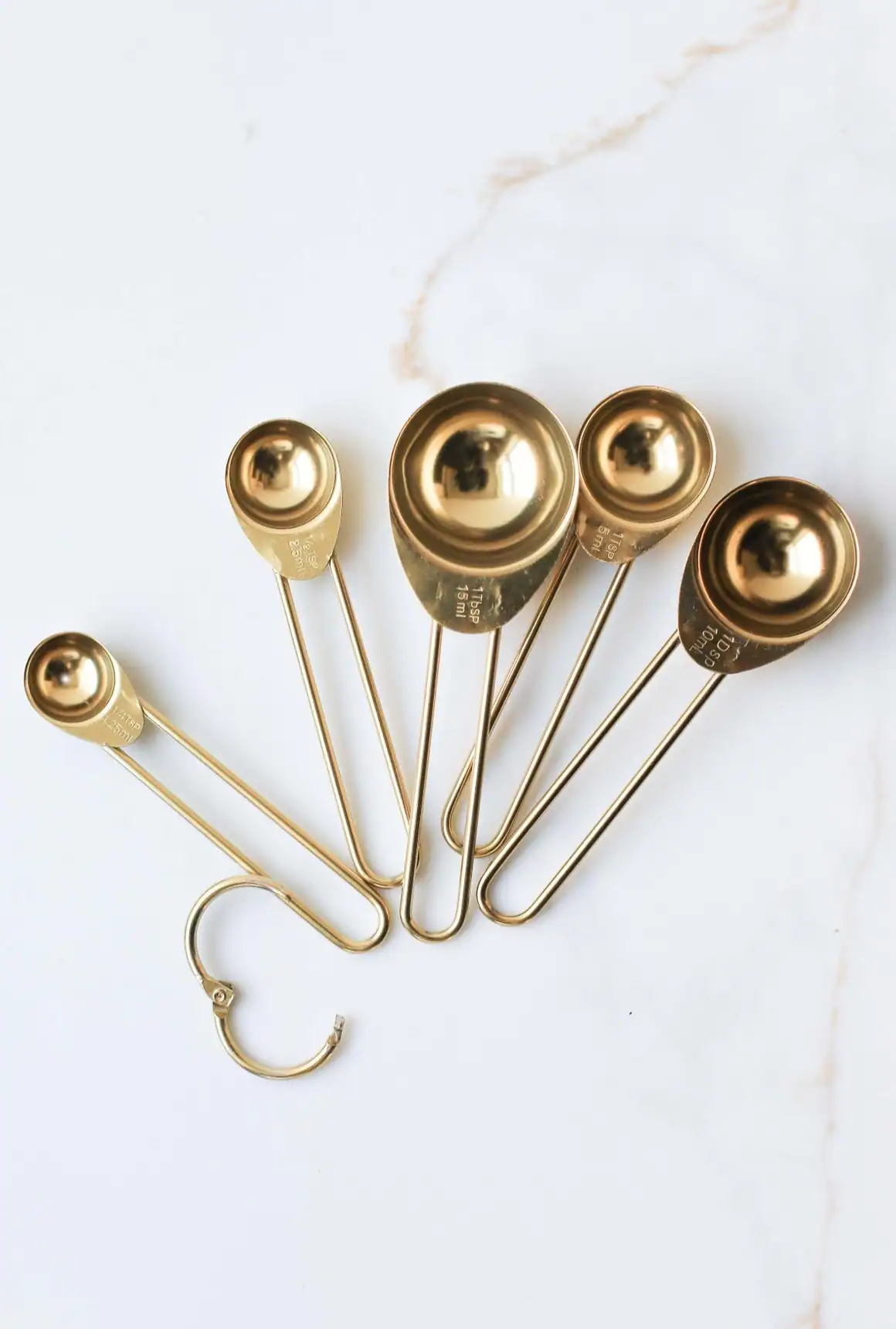 Stainless Steel Measuring Spoon Set – Precision Kitchen Measuring Tools 1.jpeg Stainless steel (gold finished) measuring spoons set on white marble background, kitchen utensils, cooking tools, culinary acce.