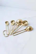 Shiny gold facial massage tools set for skincare and relaxation.