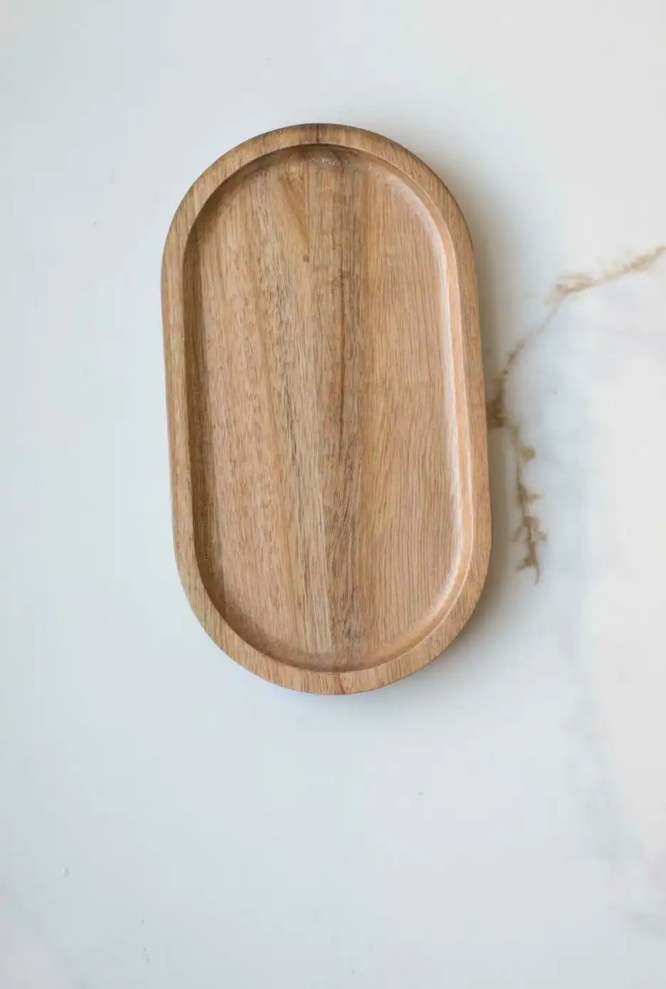 Wood Soap Tray.jpeg Wooden serving tray on white marble surface, minimalist kitchen accessory.