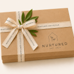 Nurtured signature gift wrapping service featuring a premium keepsake gift box with ribbon and botanical accents for beautifully packaging your selected gifts.