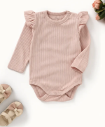 Organic cotton baby bodysuit in Blush Petal pink with flutter sleeves, long sleeves, and ribbed knit texture.