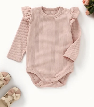 Organic cotton baby bodysuit in Blush Petal pink with flutter sleeves, long sleeves, and ribbed knit texture.